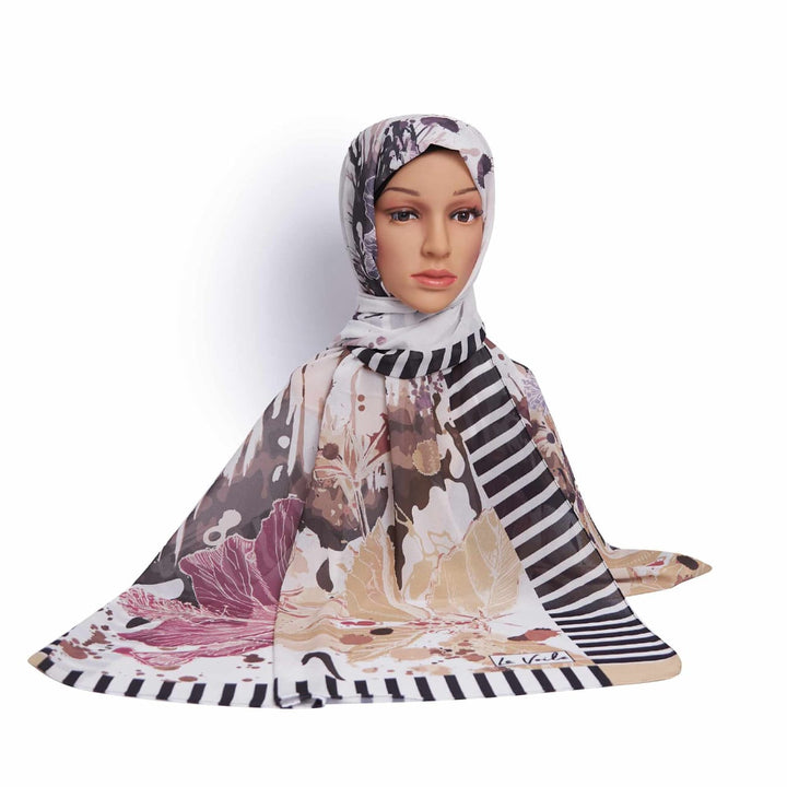 Mannequin wearing a patterned hijab with a white background