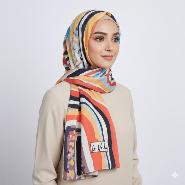 Woman wearing a colorful scarf with 'La Vela' branding on a light gray background