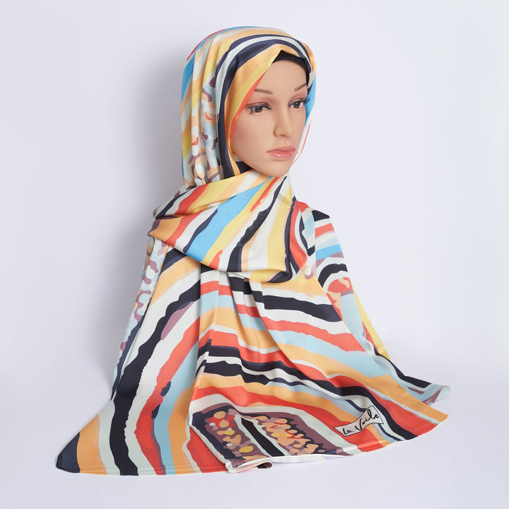 Woman wearing a colorful patterned hijab on a white background