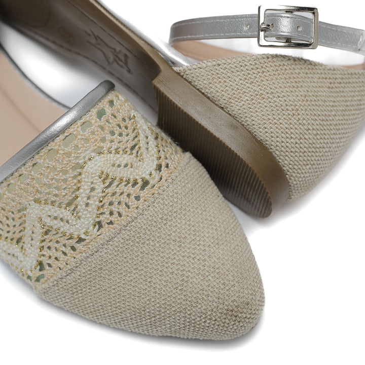 beige flat shoe with detailed lace and stitched toe